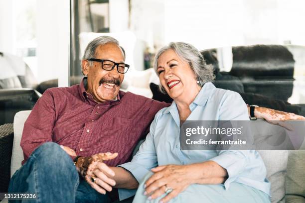 senior couple flirting on the porch - latin american and hispanic stock pictures, royalty-free photos & images