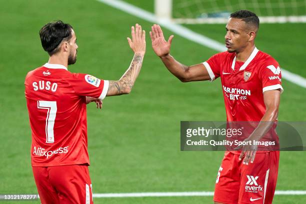 Fernando Reges of Sevilla FC celebrates with Suso after scoring his team's second goal during the La Liga Santander match between RC Celta and...