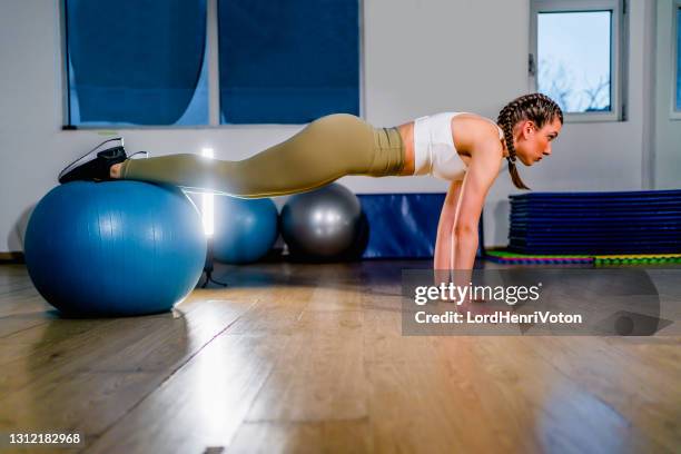 fit woman workout with fitness ball - fitness ball stock pictures, royalty-free photos & images