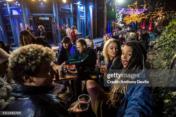 Woman reacts to the camera outside G-A-Y bar on Canal Street on April 12, 2021 in Manchester, England. England has taken a significant step in easing...