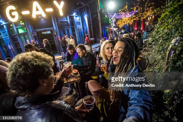 Woman reacts to the camera outside G-A-Y bar on Canal Street on April 12, 2021 in Manchester, England. England has taken a significant step in easing...