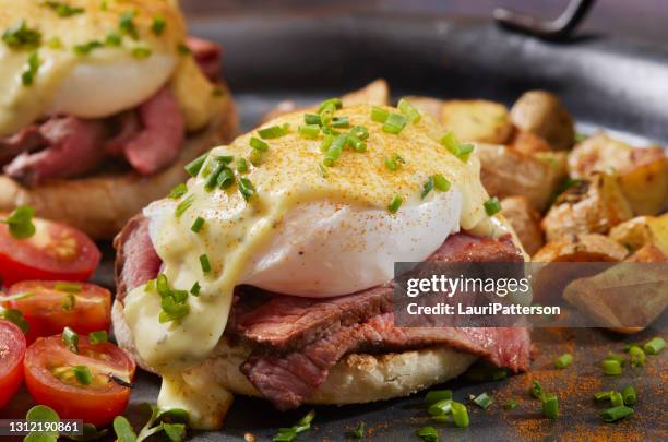 medium rare steak benedict on toasted english muffin - english muffin stock pictures, royalty-free photos & images
