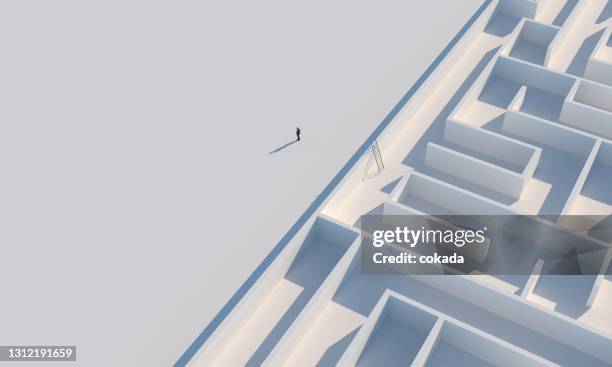 businessman escaping from maze - escaping maze stock pictures, royalty-free photos & images