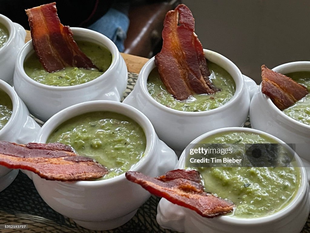 Fresh pea cucumber mint gazpacho soup with bacon strip garnish