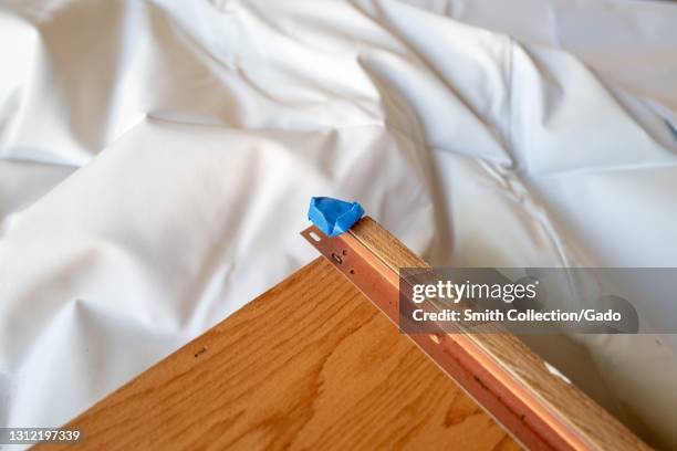 Close-up of drawer, showing process of refinishing cabinets, a home renovation project, on dropcloth in Lafayette, California, November 17, 2020.