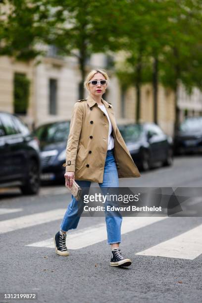 Stylist Emy Venturini @sustainably_by_emy wears Ray-Ban white sunglasses, a beige jacket from Burberry, a white sweater from CDG Comme des garçons,...
