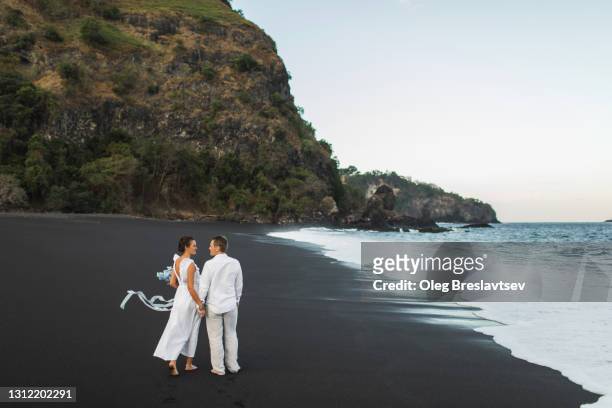 wedding couple enjoying on beach in bali. young and happy. tropical destination wedding - destination wedding imagens e fotografias de stock
