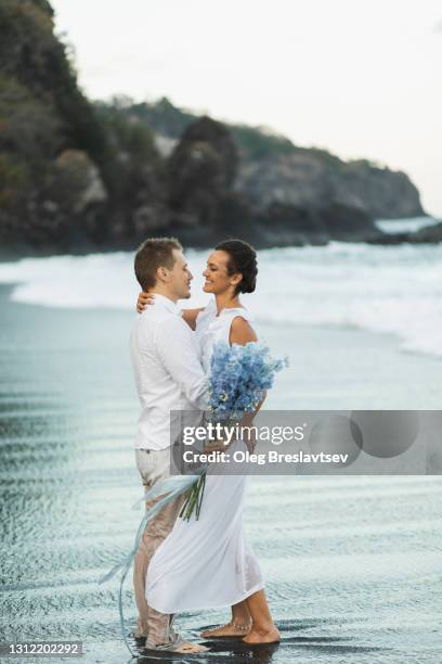 wedding couple enjoying on beach in bali. young and happy. tropical destination wedding - riddarsporresläktet bildbanksfoton och bilder