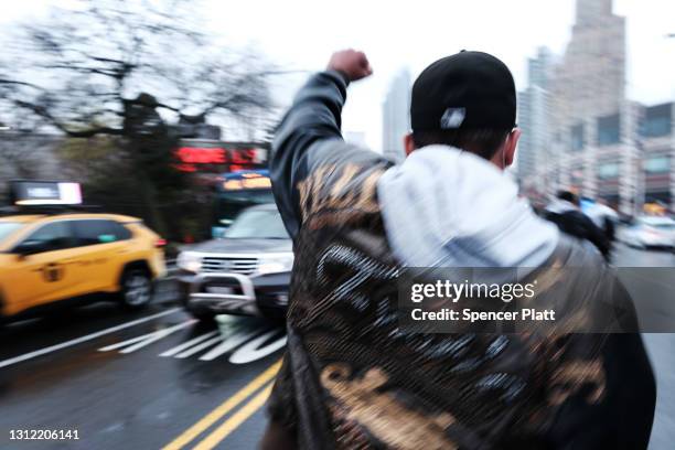 Demonstrators march through the streets to protest the recent killing of a man by police in Minnesota on April 12, 2021 in the Brooklyn borough of...