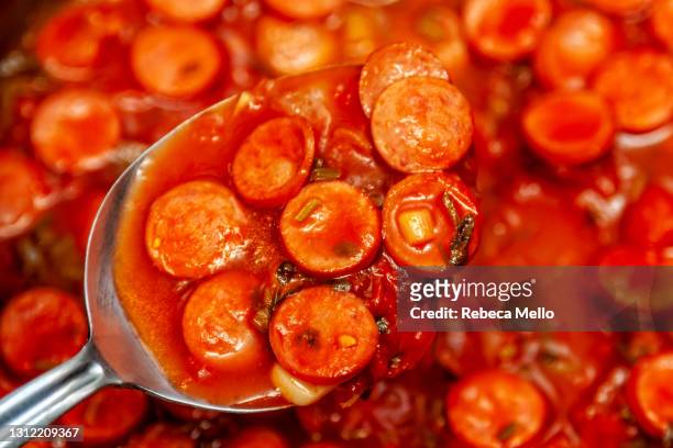 seen from above, tomato sauce and sausage in a spoon - cooked sausage stock-fotos und bilder