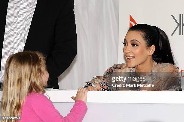 Kim Kardashian speaks to a young fan at a promotion for the Kardashian Kollection Handbag range at Westfield Miranda on November 3, 2011 in Sydney,...