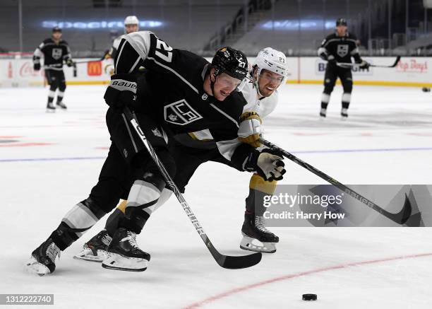 Austin Wagner of the Los Angeles Kings fends off Shea Theodore of the Vegas Golden Knights as he skates to the goal during the second period at...