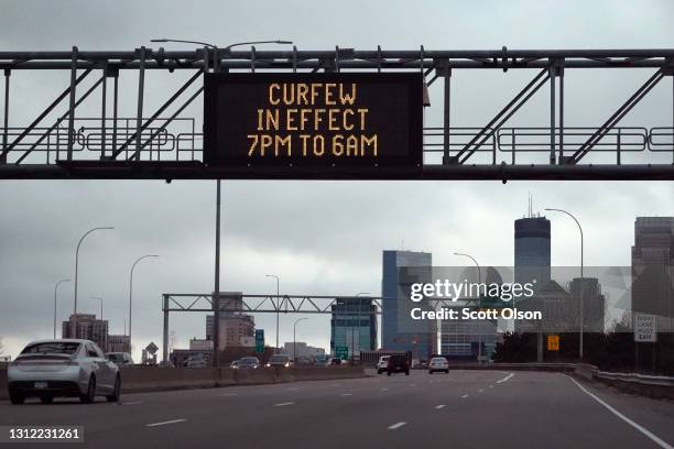 Sign above the interstate warns residents and visitors of a curfew put in place in an attempt to curtail violence on April 12, 2021 in Minneapolis,...