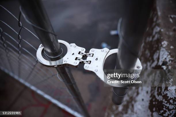 Handcuff is used to secure fences to keep demonstrators away from the Brooklyn Center police station on April 12, 2021 in Brooklyn Center, Minnesota....