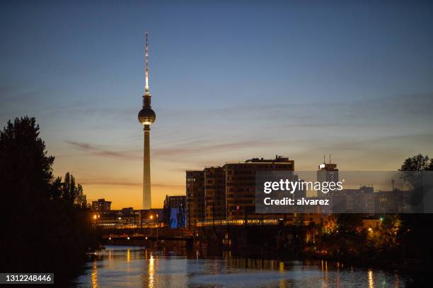 berlin skyline with famous tv tower at alexanderplatz at night - communications tower sunset stock pictures, royalty-free photos & images