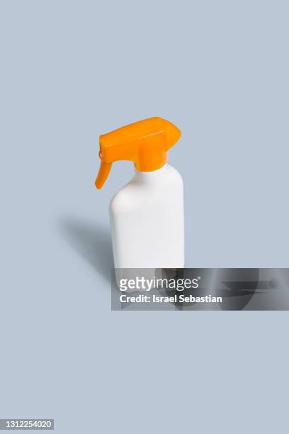 close-up view of a white and yellow bottle of sunscreen on a light blue background. mockup concept - can beach sun photos et images de collection