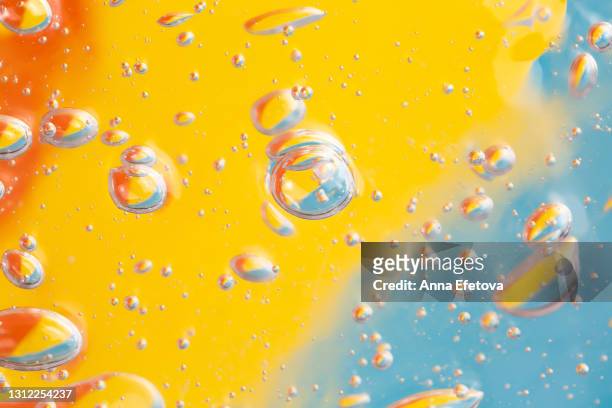 texture of organic transparent aloe vera gel or moisturizing lotion with many air bubbles on orange illuminating yellow blue background. concept of skin care procedures with healthy cosmetic products. close-up and flat lay style with copy space - carbonation foto e immagini stock