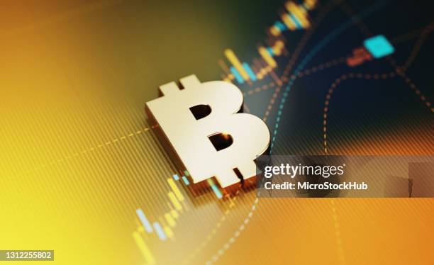 concept d’investissement et de finance - symbole de bitcoin se reposant sur l’arrière-plan jaune de graphique financier - taux de change photos et images de collection