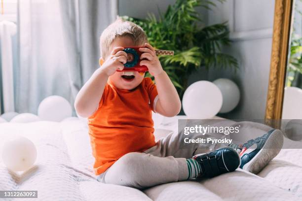 baby boy photographer playing with toy camera - toy camera stock pictures, royalty-free photos & images