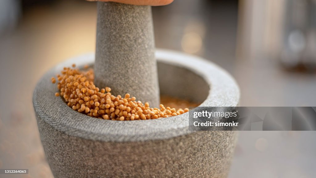 Mustard seeds in mortar and pestle