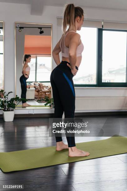 young pretty woman practicing yoga at home - coronavirus moldova stock pictures, royalty-free photos & images