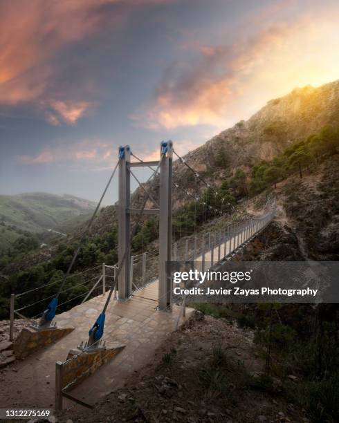 suspension rope bridge in mountain environment at sunset - rope length stock pictures, royalty-free photos & images