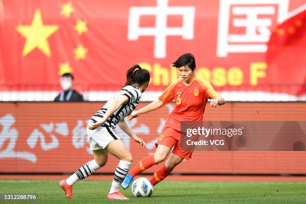Zhang Xin of China and Kang Chae-rim of South Korea fight for the ball during the Tokyo Olympics Women's Football Asian Final Qualifier 2nd leg match...