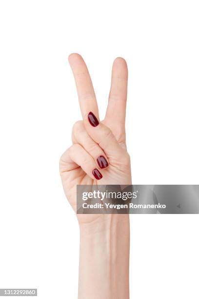 woman's hand showing victory sign, isolated on white background - peace fotografías e imágenes de stock