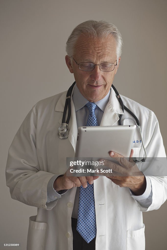 Medical doctor reading a digital tablet