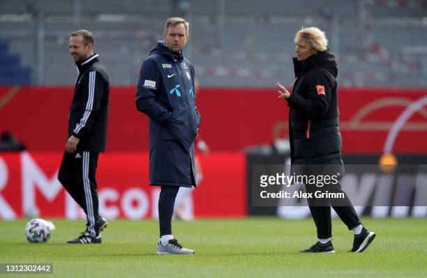 Martina Voss-Tecklenburg , head of Germany talks to Martin Sjögren, head coach of Norway ahead of the Women's International Friendly match between...