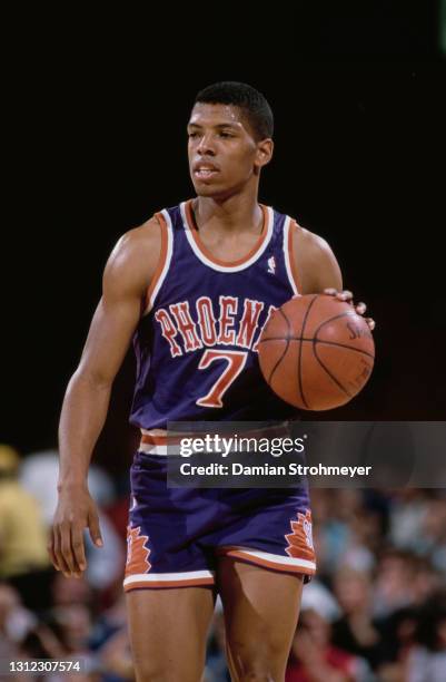 Kevin Johnson, Point Guard for the Phoenix Suns dribbles the basketball downfield during the NBA Midwest Division basketball game against the Denver...