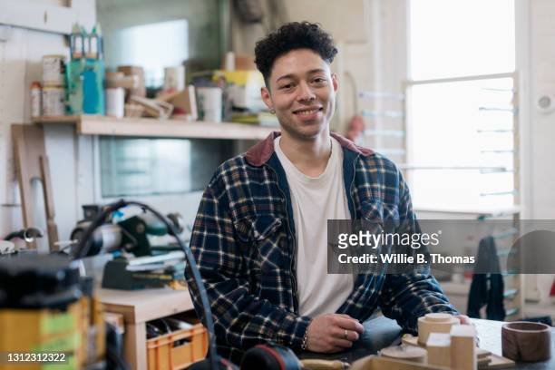 portrait of smiling woodworking student - toples stockfoto's en -beelden