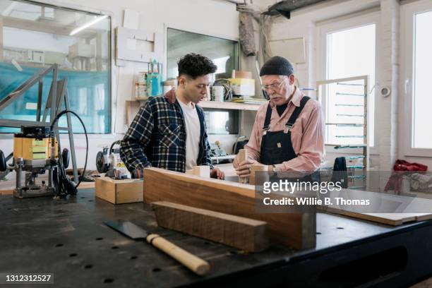 student watching while technician explains wood working techniques - carpenter stock pictures, royalty-free photos & images