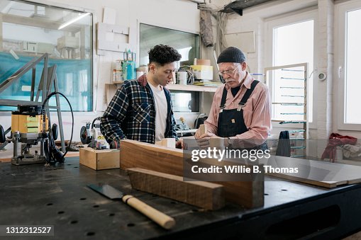 Student Watching While Technician Explains Wood Working Techniques Student Watching While Technician Explains Wood Working Techniques