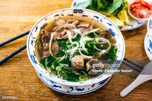 vietnamese pho soup with beef, close-up - vietnamese coriander stock pictures, royalty-free photos & images