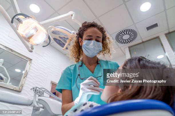 dentist woman examining little girl - dental patient stock pictures, royalty-free photos & images