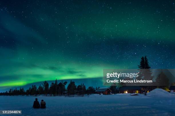 watching a night sky with aurora borealis - sweden house stock pictures, royalty-free photos & images