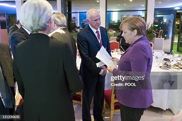 German Chancellor Angela Merkel talks with Greek Prime Minister George Papandreou on November 2, 2011 on the eve of the start of the G20 Summit of...