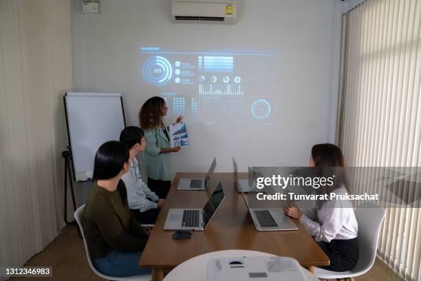 team of young engineer meeting in office with graphic on monitor . - employee engagement graphic stock pictures, royalty-free photos & images