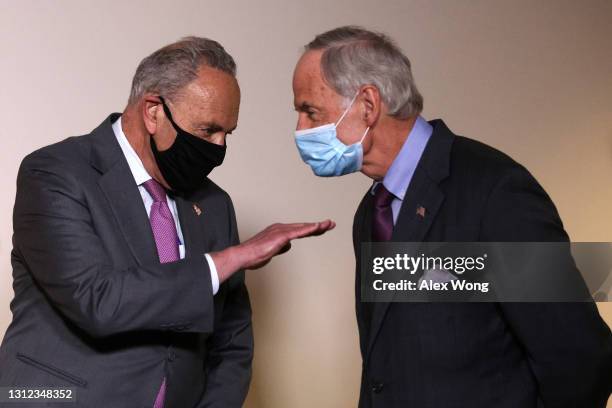 Senate Majority Leader Sen. Chuck Schumer talks to Sen. Tom Carper during a news briefing after a weekly Senate Democratic Policy Luncheon at Hart...