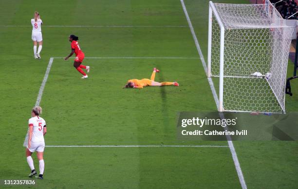 Karen Bardsley of England looks dejected as Nichelle Prince of Canada celebrates after scoring their team's second goal during the International...