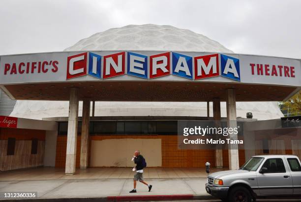 Person walks past the famed Cinerama Dome at the shuttered ArcLight Hollywood movie theater on April 13, 2021 in Los Angeles, California. Decurion,...