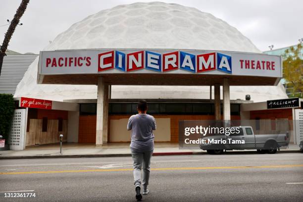 Person takes photos of the famed Cinerama Dome at the shuttered ArcLight Hollywood movie theater on April 13, 2021 in Los Angeles, California....