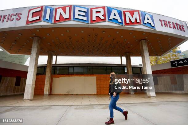 Person walks past a boarded up entrance at the famed Cinerama Dome at the shuttered ArcLight Hollywood movie theater on April 13, 2021 in Los...
