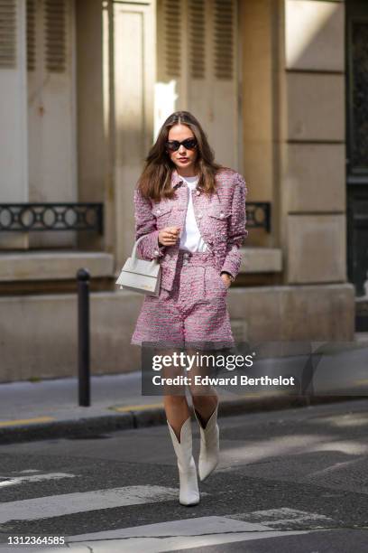 Therese Hellström @tesshell wears sunglasses, a white t-shirt, a gray purple / pink tweed knit jacket with pearls, purple / pink tweed knit shorts, a...