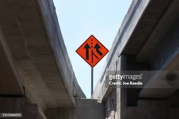 Construction sign is seen as workers build the “Signature Bridge,” replacing and improving a busy highway intersection at I-95 and I-395 on April 13,...