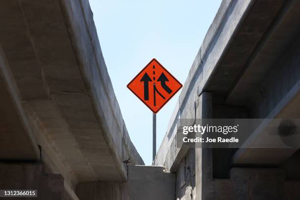 Construction sign is seen as workers build the “Signature Bridge,” replacing and improving a busy highway intersection at I-95 and I-395 on April 13,...