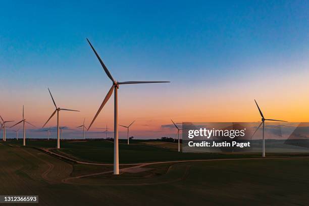 drone view of a wind farm. multiple wind turbines - energía eólica fotografías e imágenes de stock