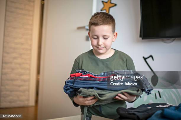 children sorting clothes from their closet for donation - clear donation box stock pictures, royalty-free photos & images