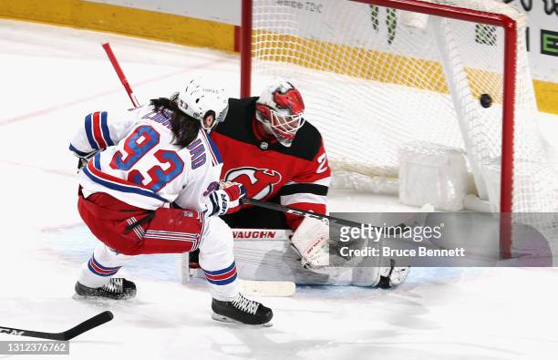 Mika Zibanejad of the New York Rangers scores at 7:02 of the first period against Mackenzie Blackwood of the New Jersey Devils at the Prudential...